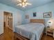 Bedroom with light blue walls, wood floors, and access to hallway at 821 Ralph Mcgill Ne Blvd # 2303, Atlanta, GA 30306