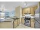 Well-equipped kitchen featuring granite countertops and stainless steel appliances that seamlessly connect to living area at 821 Ralph Mcgill Ne Blvd # 2303, Atlanta, GA 30306