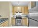 Modern kitchen featuring granite countertops, stainless steel appliances, and light wood cabinets with ample storage space at 821 Ralph Mcgill Ne Blvd # 2303, Atlanta, GA 30306