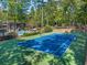 Blue tennis court with green perimeter and pool view at 2707 Cumberland Se Ct, Smyrna, GA 30080