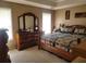 Main bedroom with large bed, dresser, and mirrored vanity at 155 Vinnys Way, Covington, GA 30014