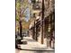 Sidewalk view of brick buildings with shops and trees in the fall at 2641 Mackintosh Ct # 9, Brookhaven, GA 30319