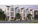 Exterior of three-story townhomes with white brick and dark trim at 2641 Mackintosh Ct # 9, Brookhaven, GA 30319