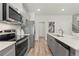 Modern kitchen with gray cabinets and stainless steel appliances at 413 Brooch Way, Stockbridge, GA 30281