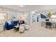 Spacious loft area with blue velvet sofa and geometric patterned wall at 417 Brooch Way, Stockbridge, GA 30281