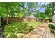 Spacious backyard with a deck, wooden privacy fence, and a lush lawn at 1507 Lively Ridge Ne Rd, Atlanta, GA 30329