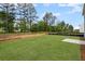A spacious backyard with lush green grass, young trees, and a concrete patio for outdoor enjoyment at 126 Cherry Glen Way, Euharlee, GA 30145