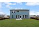 View of the home's backyard, showcasing a large lawn and an abundance of natural light at 126 Cherry Glen Way, Euharlee, GA 30145