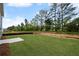 Expansive backyard featuring a large lawn, young trees, and a concrete patio area at 126 Cherry Glen Way, Euharlee, GA 30145