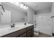 Bathroom featuring double sink vanity with dark wood cabinets, framed mirror, and tub-shower combo at 126 Cherry Glen Way, Euharlee, GA 30145