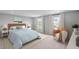 Bedroom with a large bed, accent chair, and natural light streaming through the windows at 126 Cherry Glen Way, Euharlee, GA 30145