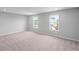 Spacious bedroom with plush carpet and large windows offering natural light and neighborhood views at 126 Cherry Glen Way, Euharlee, GA 30145