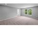 Bright, carpeted bedroom with two windows offering pleasant views and ample natural light at 126 Cherry Glen Way, Euharlee, GA 30145