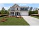 Charming two-story home features a front porch, a two-car garage, and a beautifully landscaped yard at 126 Cherry Glen Way, Euharlee, GA 30145