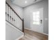 Foyer features hardwood floors, a staircase with white railings, and a front door with glass panels at 126 Cherry Glen Way, Euharlee, GA 30145