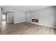Spacious living room boasts a modern fireplace, hardwood floors, and neutral gray walls at 126 Cherry Glen Way, Euharlee, GA 30145
