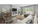 Bright living room with large windows, a fireplace, and a comfortable sofa with throw pillows at 126 Cherry Glen Way, Euharlee, GA 30145