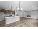 Open-concept area showcasing a modern kitchen and a cozy living room with a fireplace at 126 Cherry Glen Way, Euharlee, GA 30145