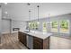 Bright living area with fireplace and kitchen featuring an island with stainless steel dishwasher at 126 Cherry Glen Way, Euharlee, GA 30145
