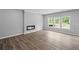 Spacious living room features a modern fireplace and several large windows at 126 Cherry Glen Way, Euharlee, GA 30145