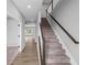Interior shot features a carpeted staircase with a wooden handrail and a view of hardwood floors at 126 Cherry Glen Way, Euharlee, GA 30145
