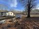 Backyard with sheds and leaf-covered ground at 3965 Pecan Rd, Loganville, GA 30052