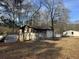 Backyard with various sheds and debris at 3965 Pecan Rd, Loganville, GA 30052