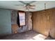 Features wood paneling and a ceiling fan. Needs updating at 3965 Pecan Rd, Loganville, GA 30052