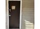 Dark brown front door with small window at 3965 Pecan Rd, Loganville, GA 30052