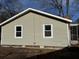 Tan house exterior with white framed windows at 3965 Pecan Rd, Loganville, GA 30052
