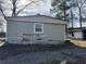 Damaged beige house exterior with storm damage at 3965 Pecan Rd, Loganville, GA 30052
