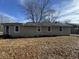 Tan house exterior with a spacious backyard at 3965 Pecan Rd, Loganville, GA 30052