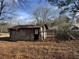 Damaged block shed with plywood siding at 3965 Pecan Rd, Loganville, GA 30052