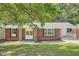 Brick ranch home with a large yard and mature trees at 895 Kings Grant Nw Dr, Atlanta, GA 30318
