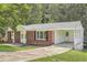 Ranch house with carport and mature trees in front at 895 Kings Grant Nw Dr, Atlanta, GA 30318