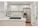Updated kitchen with stainless steel appliances and white cabinets at 895 Kings Grant Nw Dr, Atlanta, GA 30318