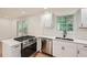 Renovated kitchen with stainless steel appliances and white cabinets at 895 Kings Grant Nw Dr, Atlanta, GA 30318