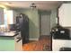 Kitchen with white cabinets, black appliances, and hardwood floors at 2280 Hickory Station Cir, Snellville, GA 30078