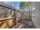 Private brick patio with wooden fence and gate at 285 Oxford Ne Pl # 4, Atlanta, GA 30307