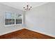 Dining room features hardwood floors and large window at 285 Oxford Ne Pl # 4, Atlanta, GA 30307
