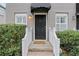 Front entrance with black door, white railings, and landscaping at 285 Oxford Ne Pl # 4, Atlanta, GA 30307