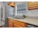 Modern kitchen with stainless steel sink and wood cabinets at 285 Oxford Ne Pl # 4, Atlanta, GA 30307