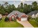 Brick home with a driveway and lush green landscaping at 10103 Harmon Springs Dr, Villa Rica, GA 30180