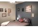 Bedroom with grey walls, featuring a comfy bed and various wall art at 10103 Harmon Springs Dr, Villa Rica, GA 30180