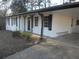 White brick ranch house with black shutters and a covered carport at 545 Oak Valley Dr, Riverdale, GA 30274