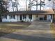 Front view of a white brick ranch house with a long driveway at 545 Oak Valley Dr, Riverdale, GA 30274