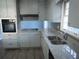 Updated kitchen featuring granite counters and stainless steel sink at 545 Oak Valley Dr, Riverdale, GA 30274