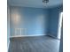 Spacious living room with light blue walls and wood-look floors at 545 Oak Valley Dr, Riverdale, GA 30274