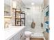 Modern bathroom with marble shower, gray vanity, and stone accent wall at 618 Cobblestone Cir, Canton, GA 30114