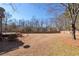 Extensive backyard with a wooden deck, patio, and mature trees at 909 Waterton Ct, Suwanee, GA 30024